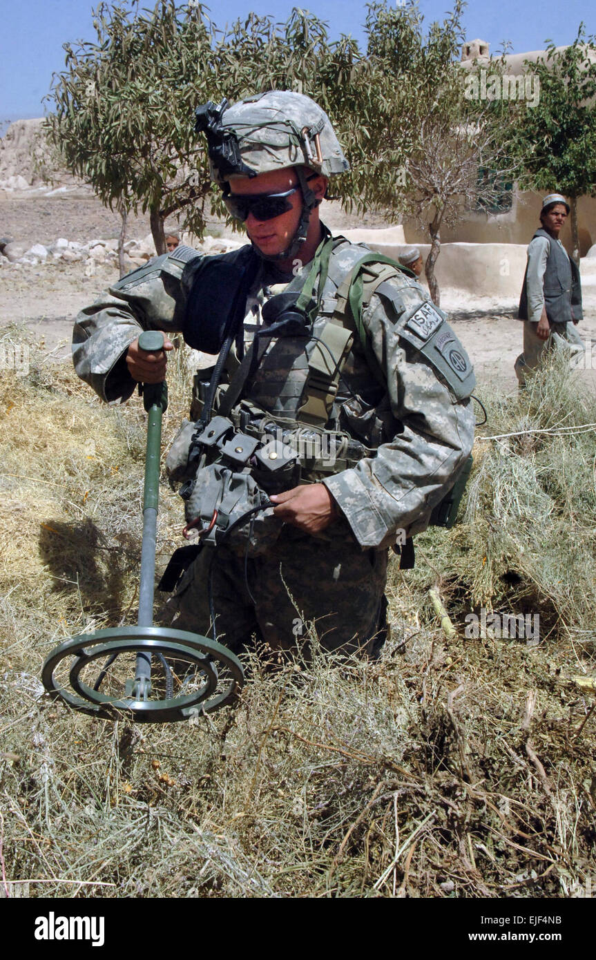 U.S. Army Spc. Clinton Marler, from Bravo Company, 2nd Battalion, 508th Parachute Infantry Regiment, uses a metal detector to search through a pile of hay during a cordon and search in Barla, Afghanistan, Sept. 6, 2007.  Staff Sgt. Michael L. Casteel Stock Photo