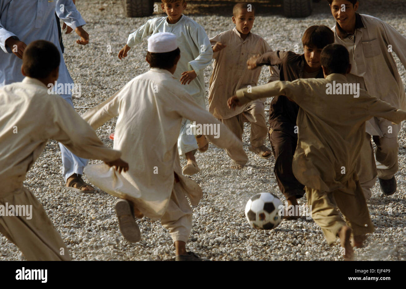 U.S. Army and Air Force personnel and local children play soccer at the Nangarhar Provincial Reconstruction Team Forward Operating Base in Jalalabad, Afghanistan, Nov. 9, 2007. The Nangarhar PRT is a joint team of U.S. Air Force Airman, Army Soldiers and representatives from the U.S. Department of State, U.S. Agency for International Development and the U.S. Department of Agriculture, responsible for helping the Government of the Islamic Republic of Afghanistan improve security, governance and promote reconstruction.  Staff Sgt. Joshua T. Jasper Stock Photo