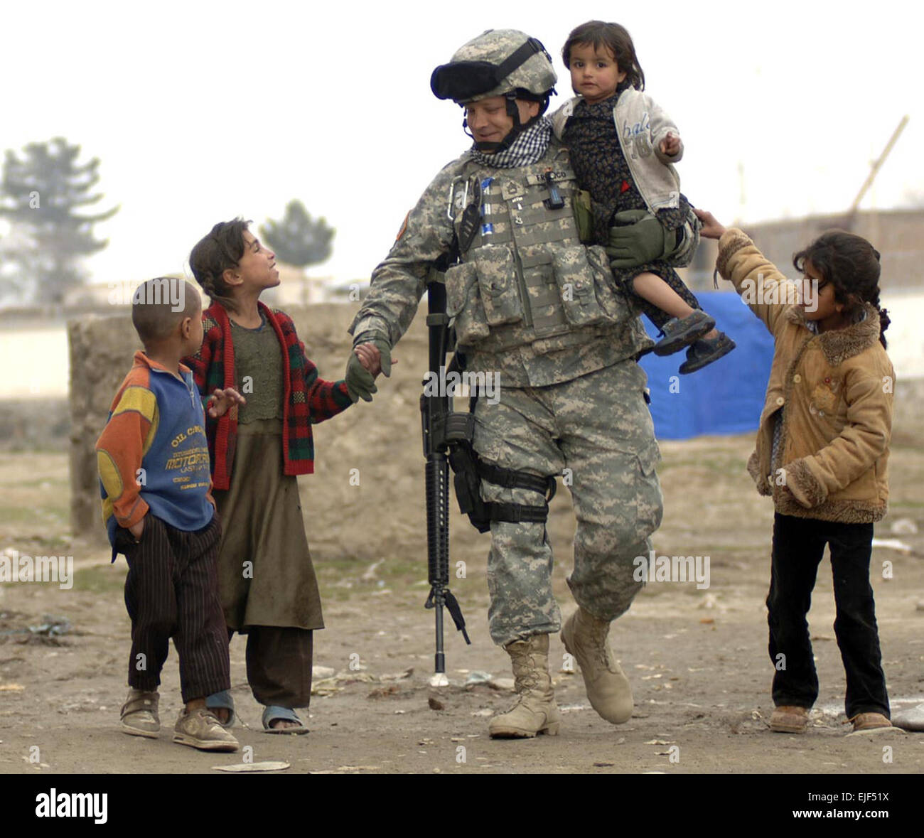 U.S. Army Sgt. 1st Class Ed Franco plays with local refugee children in Dar Ul Aman, Kabul, Afghanistan, April 8, 2007, in support of a volunteer community reach program.  The program has set up a children diversion tactic that allowed volunteers to distribute 200 bags filled with clothes, shoes and toys without distraction and is provided every month with the help of donated items from U.S. citizens.   Tech. Sgt. Cecilio M. Ricardo Jr. Stock Photo