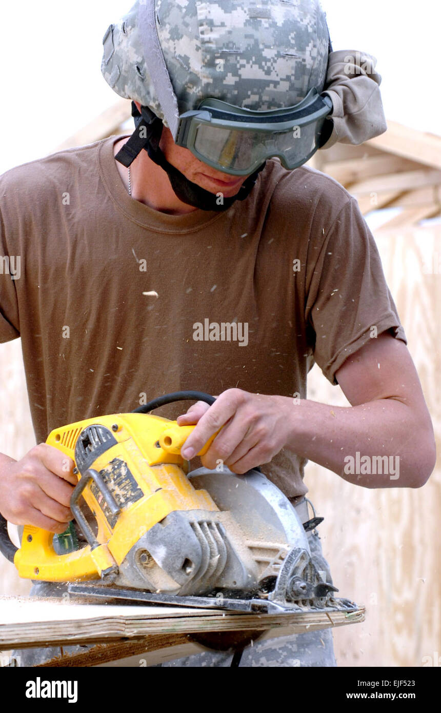 Army Sgt. Jasper G. Pothoven of the 585th Engineer Co, uses a circular saw to cut a piece of wood that will be used to finish up the B-huts being built for Task Force Spartan at Jalalabad Airfield.  Army Pfc. Melissa M. Escobar Stock Photo