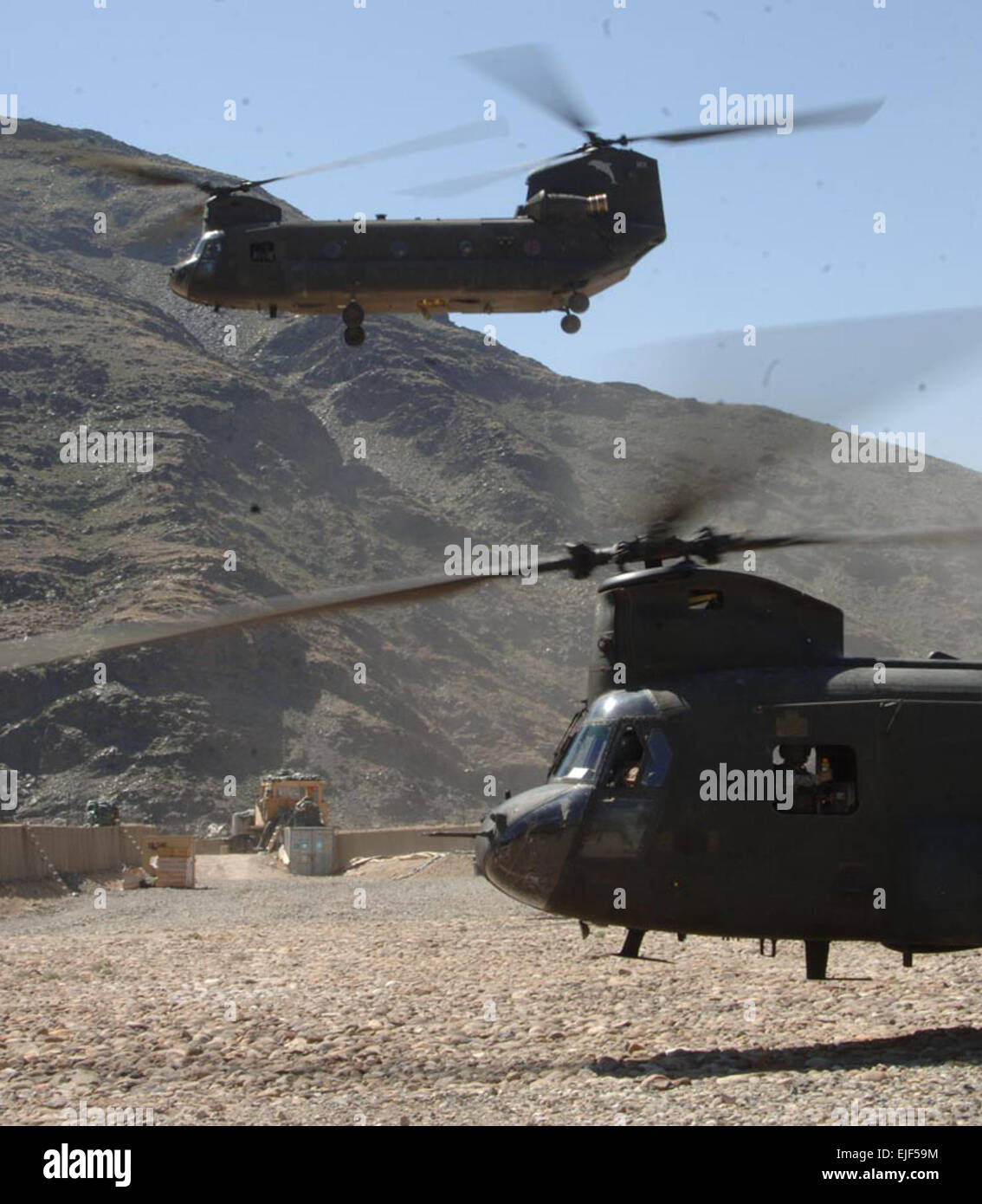 Two CH-47 Chinook helicopters from Bravo Company, 3rd General Support Aviation Battalion, 82nd Combat Aviation Brigade, 82nd Airborne Division take off after offloading mail and supplies at Forward Operating Base Kalagush in the Nuristan province of Afghanistan June 12, 2007.   Staff Sgt. Isaac A. Graham Stock Photo