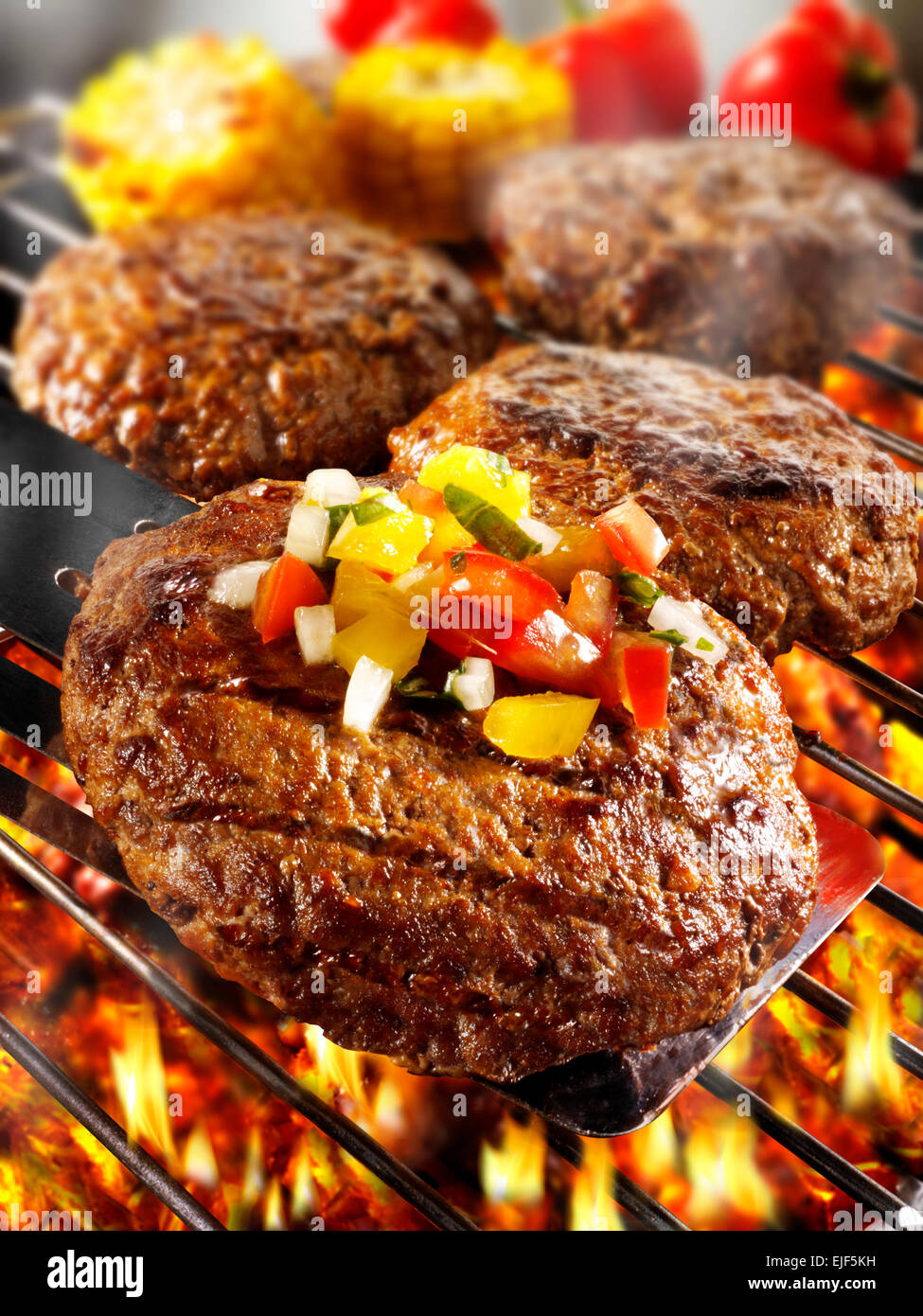 B-B-Q, barbecue burgers or hamburgers being cooked on a flaming barbecue Stock Photo