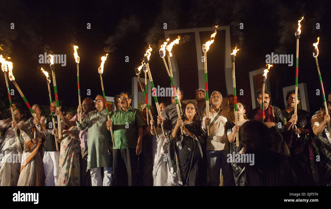 Dhaka, Bangladesh. 25th Mar, 2015. Dhaka, Bangladesh, Wednesday, March 25, 2015 ; Bangladeshi social activists hold candles during a rally in remembrance of those who were killed on this night in 1971, a day ahead of the country's declaration of independence from Pakistan.On this black night in the nationl history, the Pakistani military rulers launched ''Operation Searchlight'' killing some thousand people in that night crackdown alone. As part of the operation, tanks rolled out of Dhaka cantonment and a sleeping city woke up to the rattles of gunfire as the Pakistan army attacked the ha Stock Photo