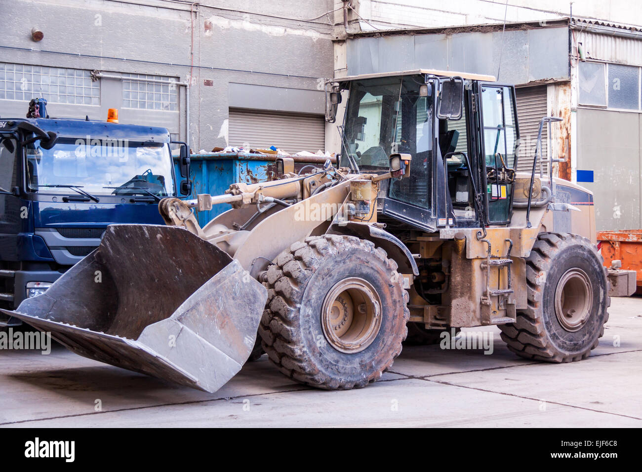 Front end loader with its bucket or scoop down parked in front of a