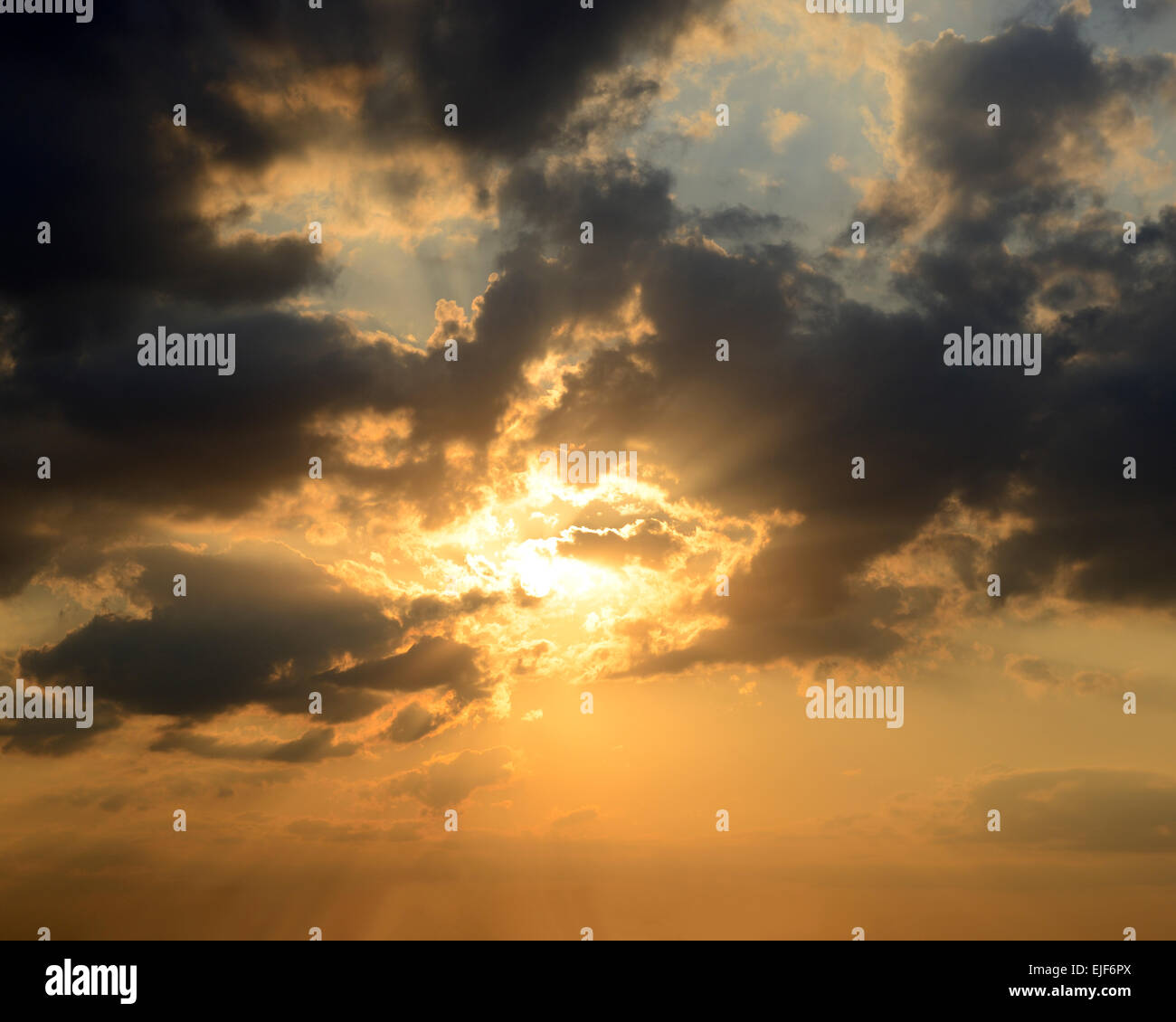 Sunset in a Dramatic Cloud Filled Sky. Stock Photo