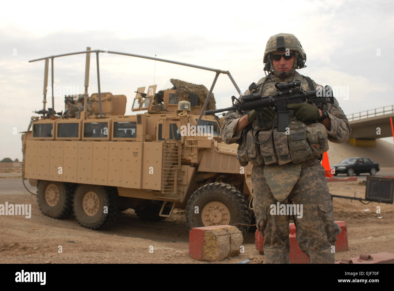 U.S Army 1st Lt. Andrew Dacey, attached to the 2nd Brigade, 1st Infantry Division, stands in front of an ambush-protected vehicle in Abu Ghraib, Iraq, March 31. Stock Photo