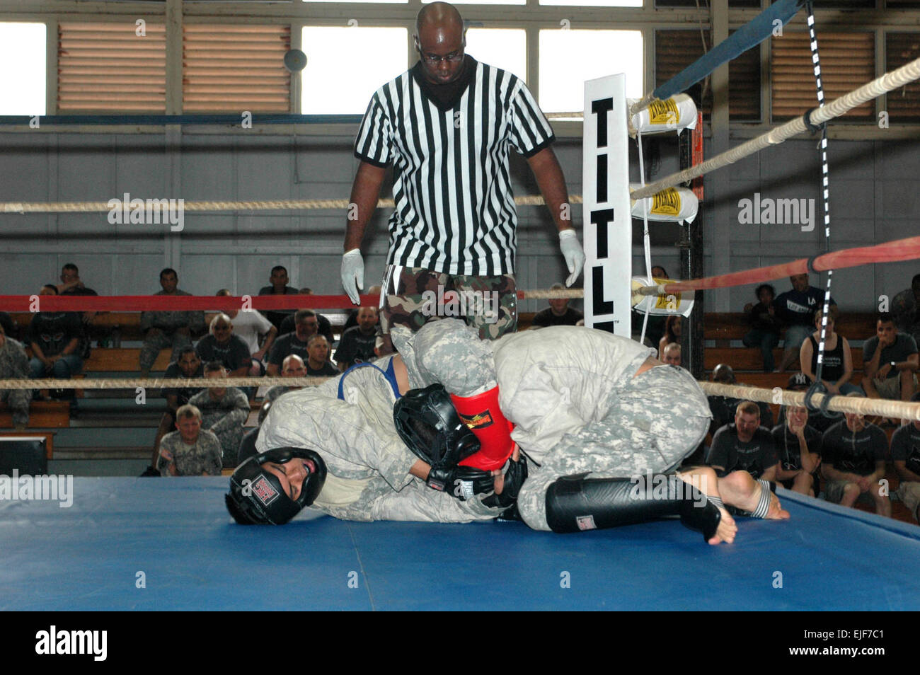 Soldiers compete in a championship match under the watchful eye of a