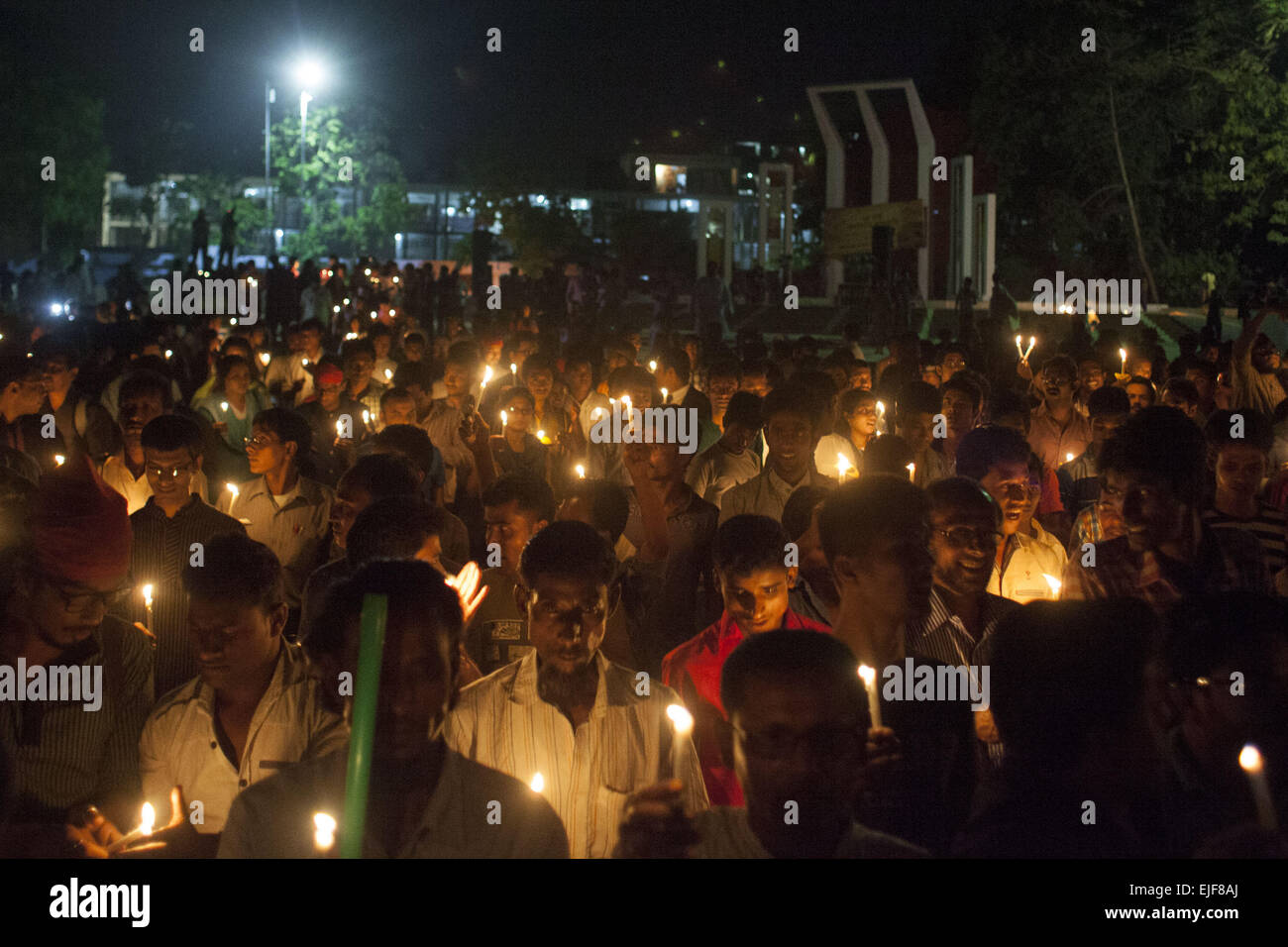 Dhaka, Bangladesh. 25th Mar, 2015. Dhaka, Bangladesh, Wednesday, March 25, 2015 ; Bangladeshi social activists hold candles during a rally in remembrance of those who were killed on this night in 1971, a day ahead of the country's declaration of independence from Pakistan.On this black night in the nationl history, the Pakistani military rulers launched ''Operation Searchlight'' killing some thousand people in that night crackdown alone. As part of the operation, tanks rolled out of Dhaka cantonment and a sleeping city woke up to the rattles of gunfire as the Pakistan army attacked the ha Stock Photo