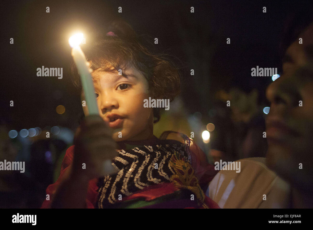 Dhaka, Bangladesh. 25th Mar, 2015. Dhaka, Bangladesh, Wednesday, March 25, 2015 ; A Bangladeshi Child hold candles during a rally in remembrance of those who were killed on this night in 1971, a day ahead of the country's declaration of independence from Pakistan.On this black night in the nationl history, the Pakistani military rulers launched ''Operation Searchlight'' killing some thousand people in that night crackdown alone. As part of the operation, tanks rolled out of Dhaka cantonment and a sleeping city woke up to the rattles of gunfire as the Pakistan army attacked the halls at Dh Stock Photo