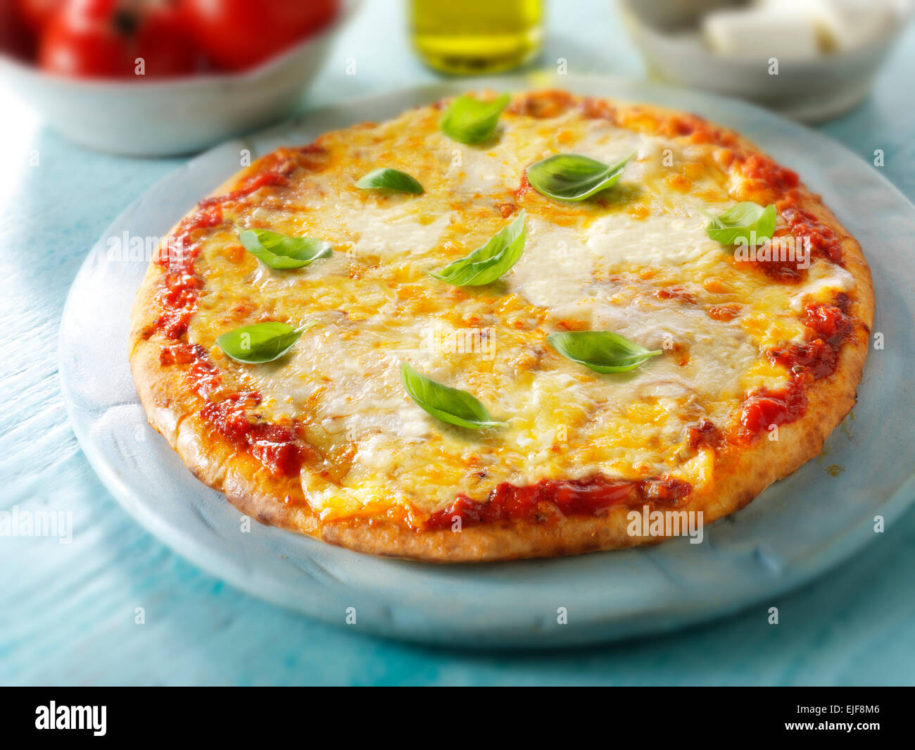 A whole Margarita Neopolitan Pizza  topped with  cheese & Basil Stock Photo