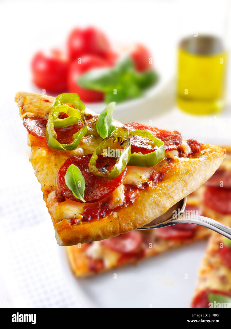 Pizza slice topped with pepperoni & cheese  with a slice out Stock Photo