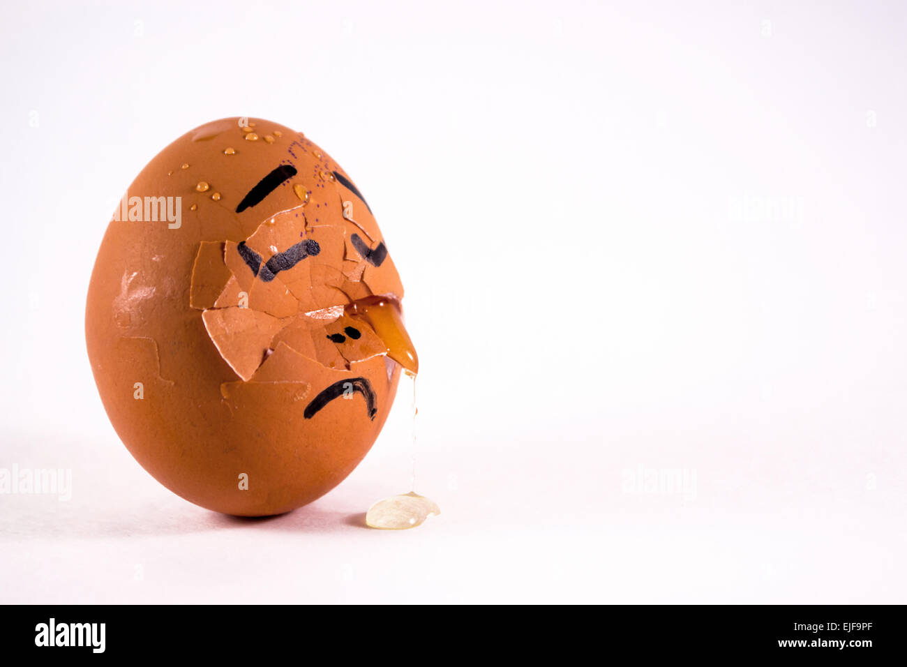 A sad crying Egg with a face and tears on a white background Stock Photo