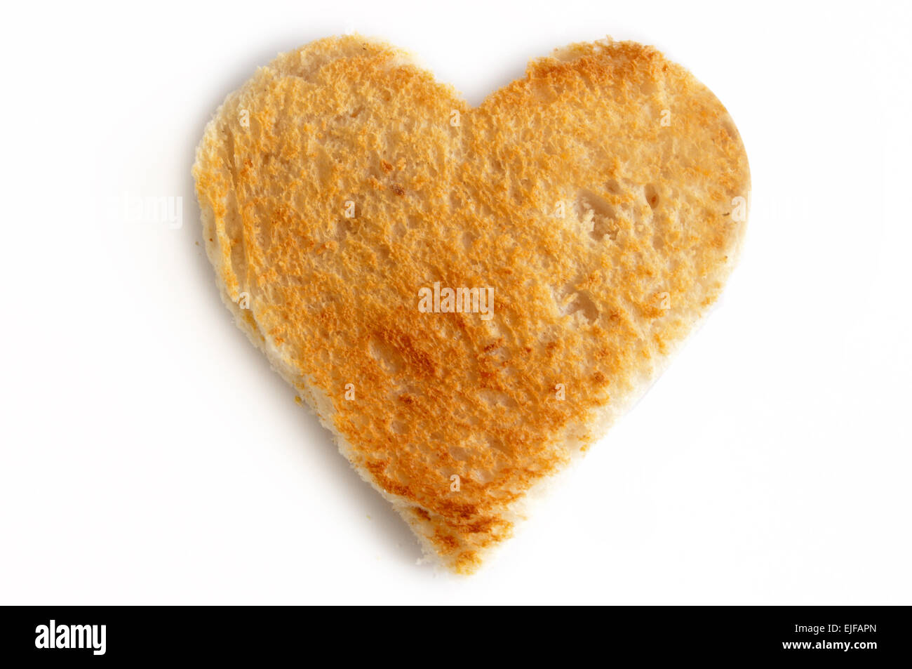 Slice of toast in a heart shape over a white background Stock Photo