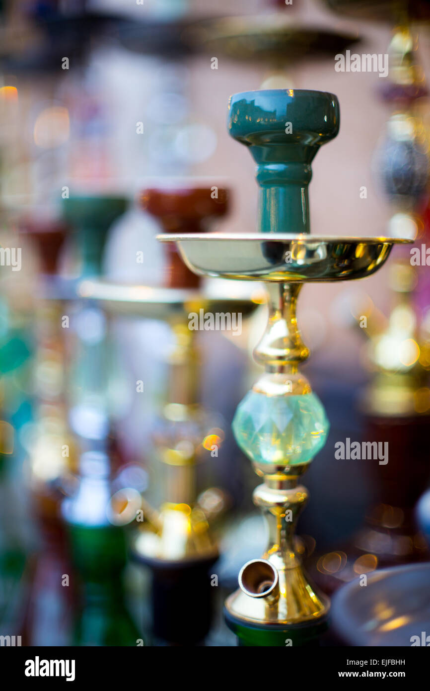 A line-up of shisha (or hubbly-bubbly) pipes on sale in Souq Waqif market in Doha, Qatar, shot with an extremely thin pland of f Stock Photo