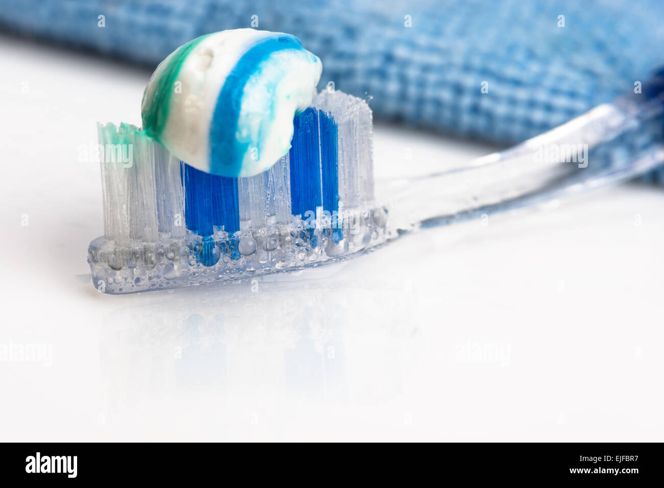toothbrush and toothpaste, towel, water spray. close-up Stock Photo - Alamy