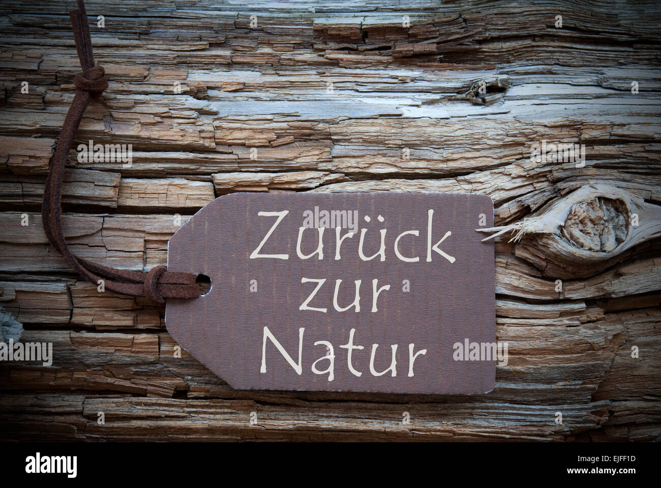 One Brown Label Or Tag With Black Ribbon On Brown Wooden Background With German Text Zurueck Zur Natur Which Means Back To Natur Stock Photo