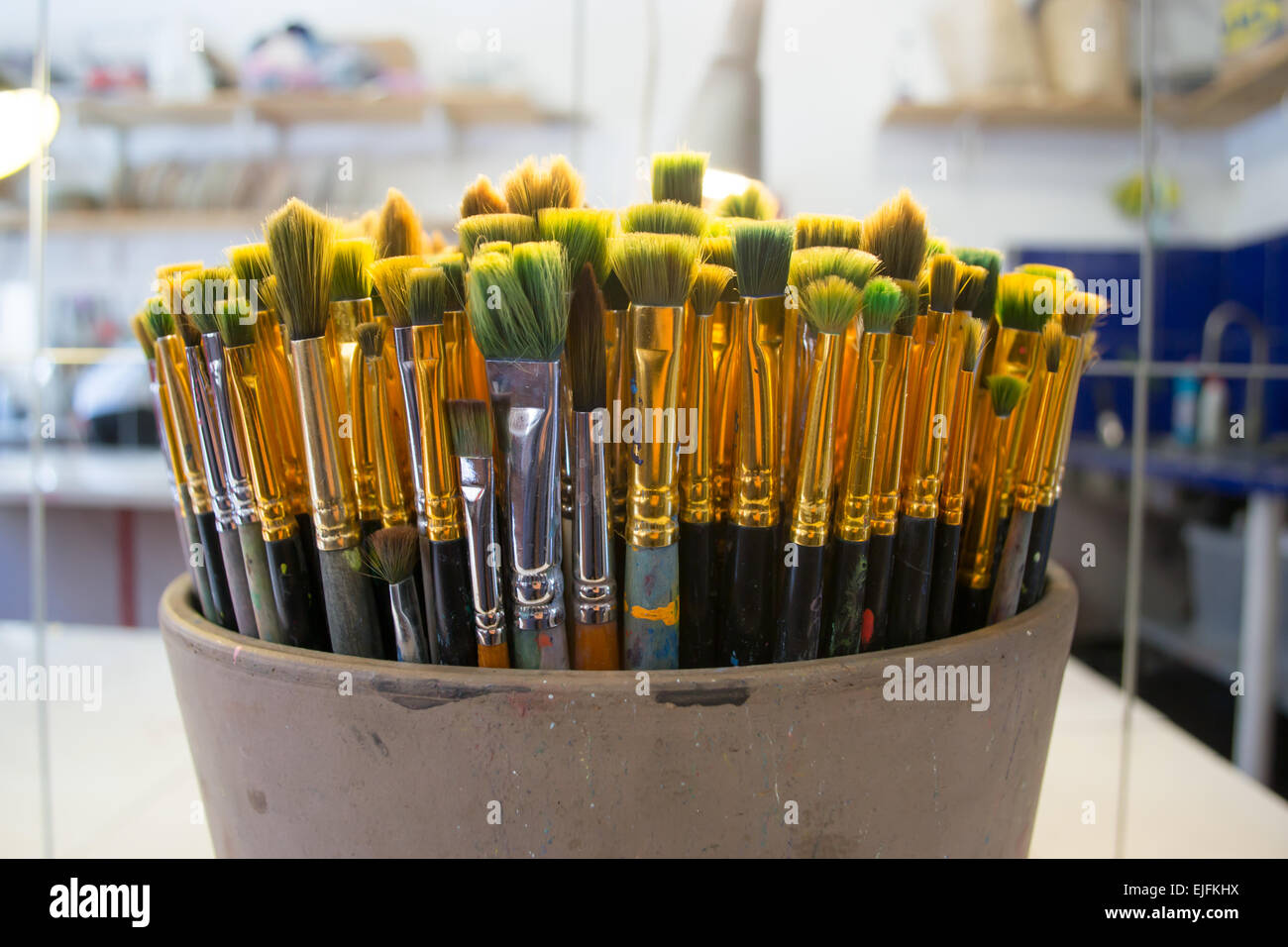 Close up of a bunch of art brushes in a metal pot Stock Photo