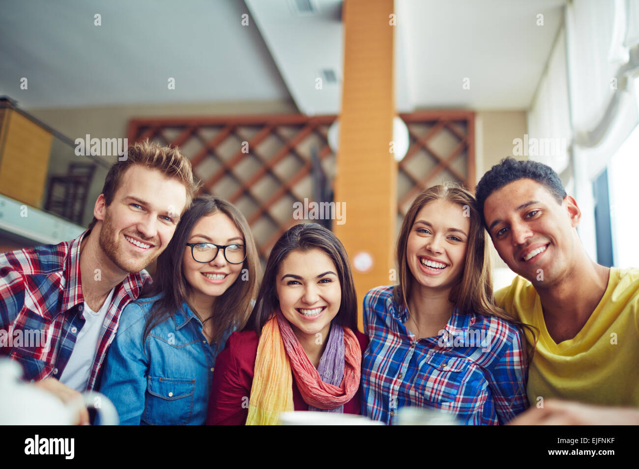 Five friendly young people looking at camera Stock Photo