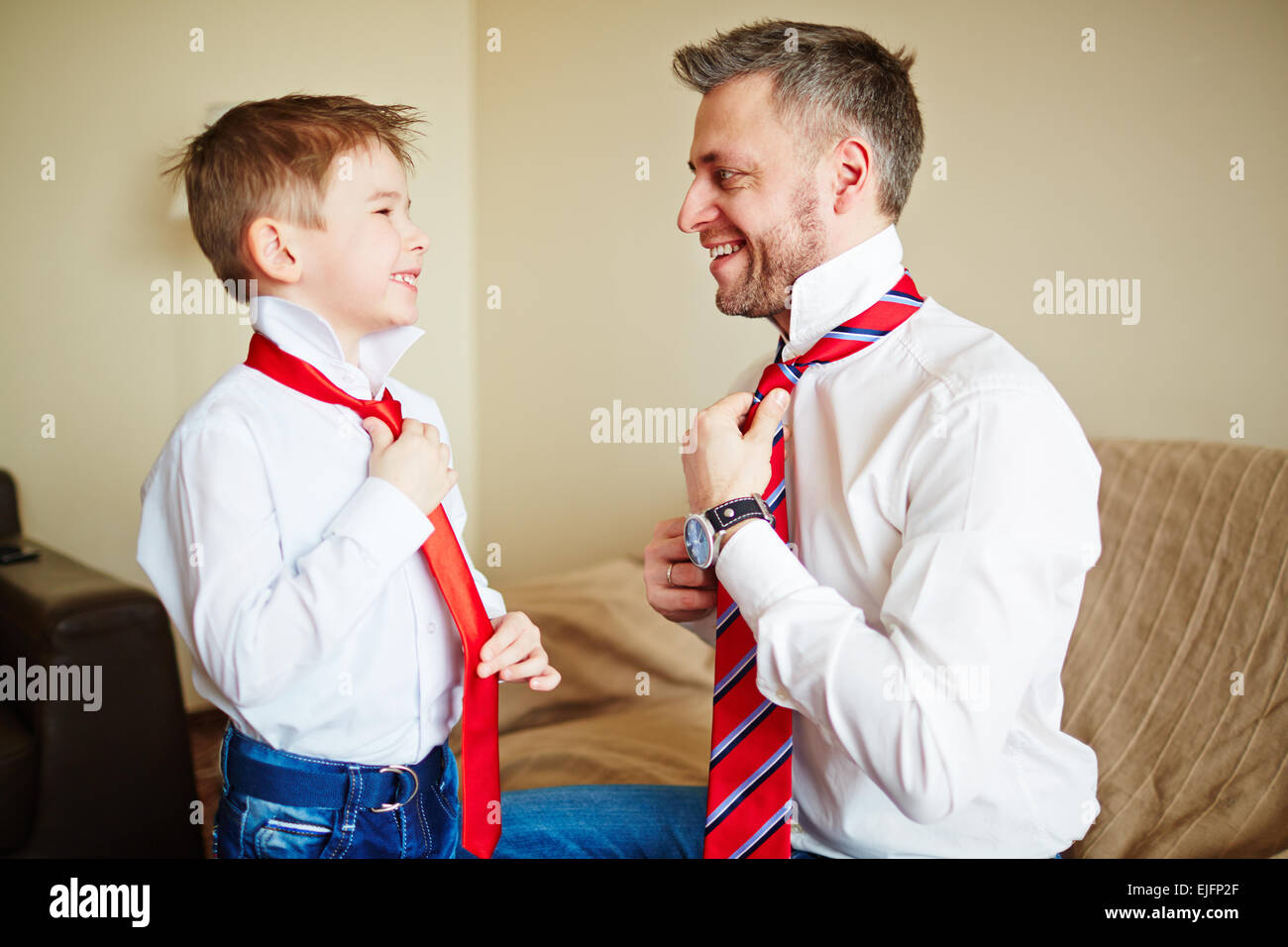 Father and son knotting ties Stock Photo