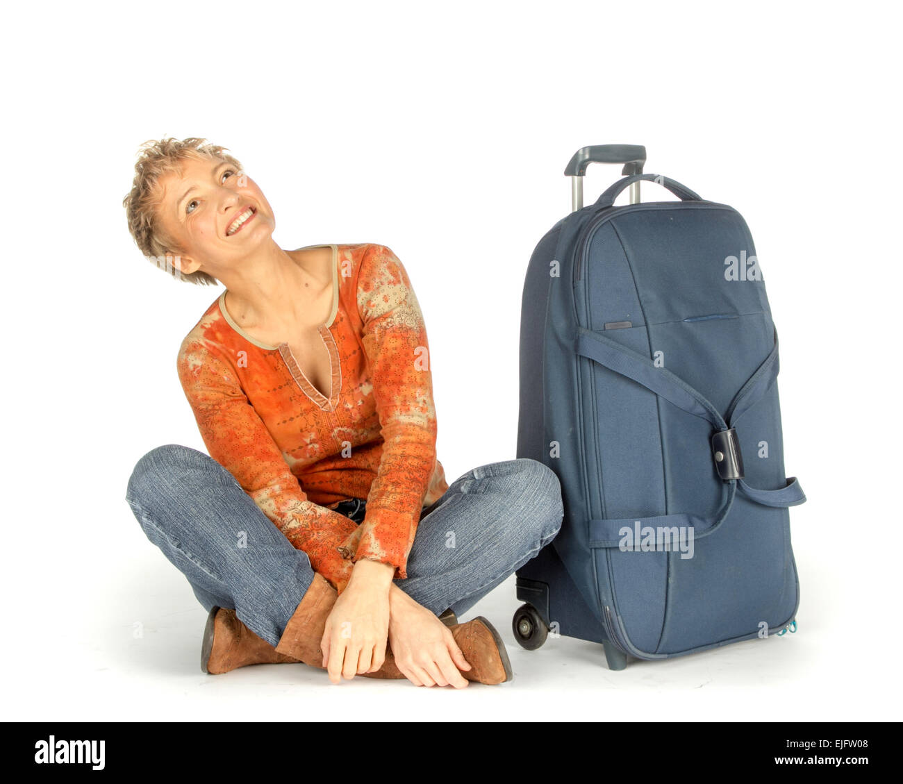 Woman sitting with suitcase on white Stock Photo