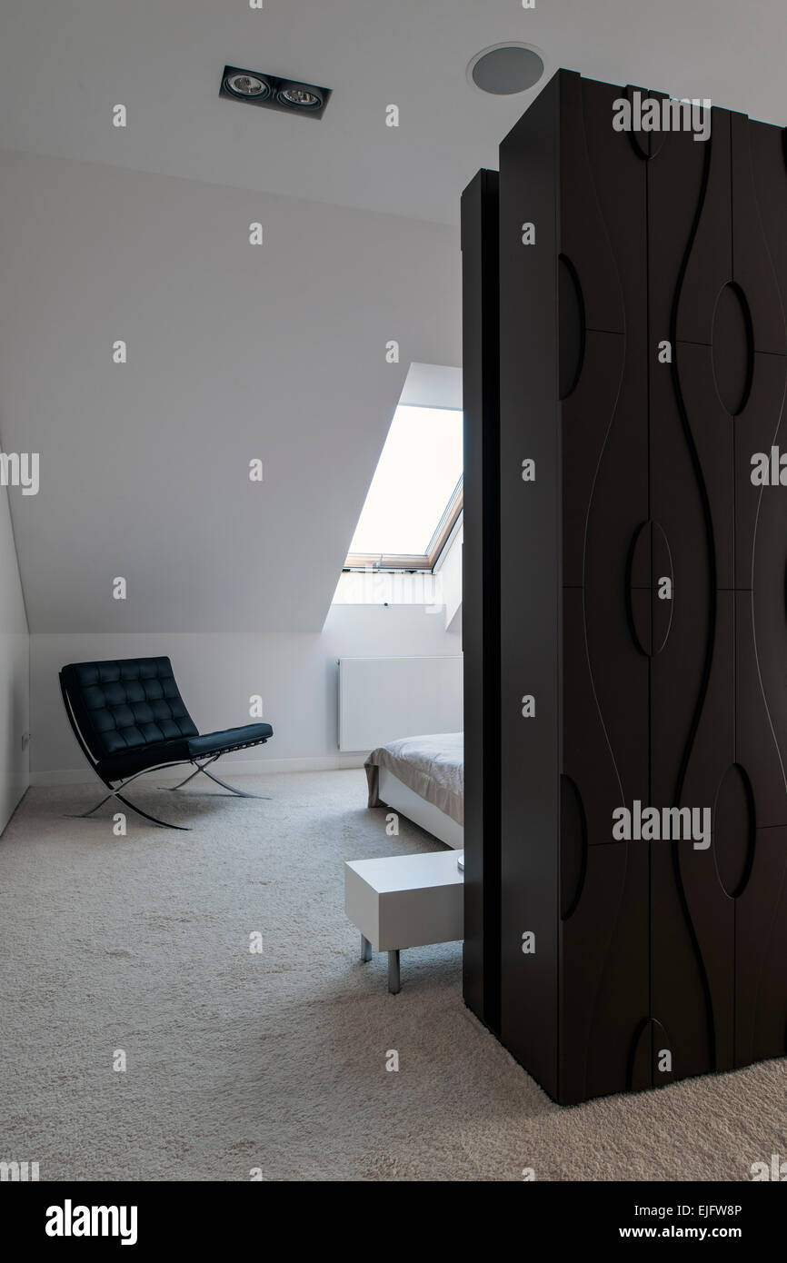 Master bethroom features roof windows and Barcelona Chair. House Lus, Poznan, Poland. Architect