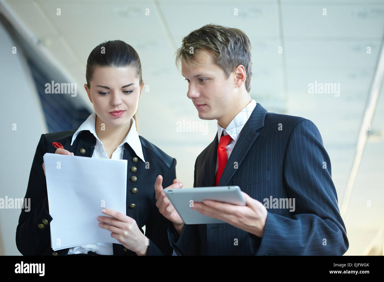 Young business woman and businessman in the hallway Stock Photo - Alamy