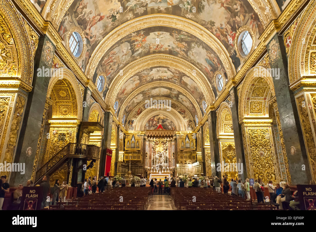 Baroque church, ornately decorated interior, golden decorations and ceiling paintings, nave, St. John's Co-Cathedral Stock Photo