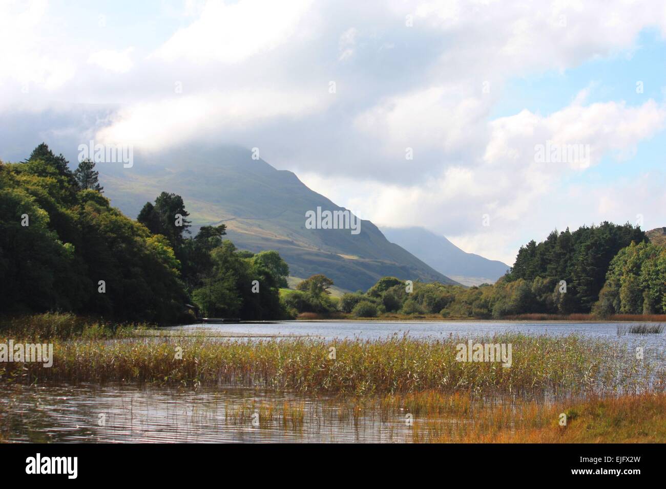 Mountain behind a lake under a moody sky Stock Photo
