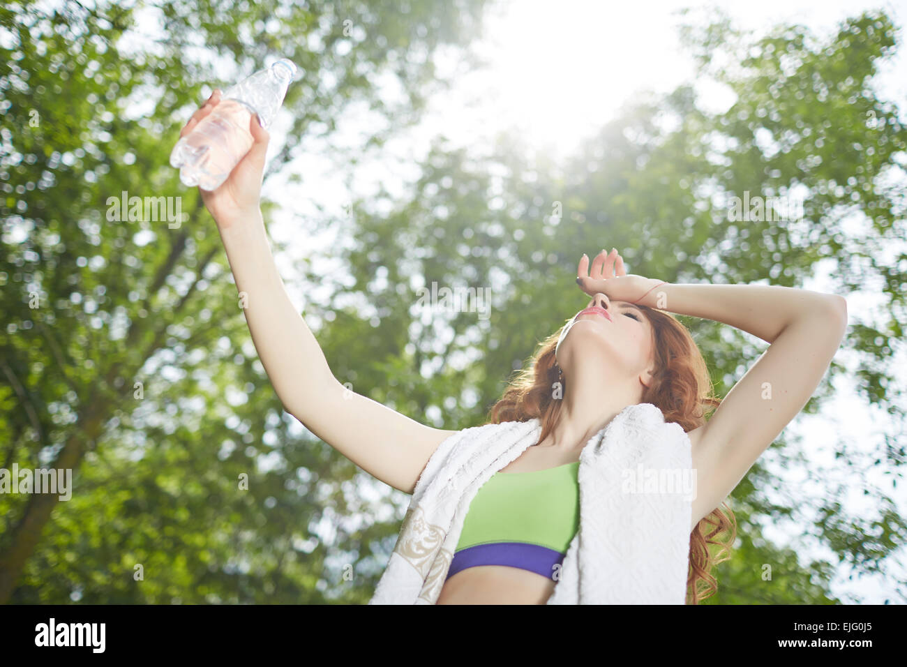 sportswoman with a bottle of water and towel at the park Stock Photo ...