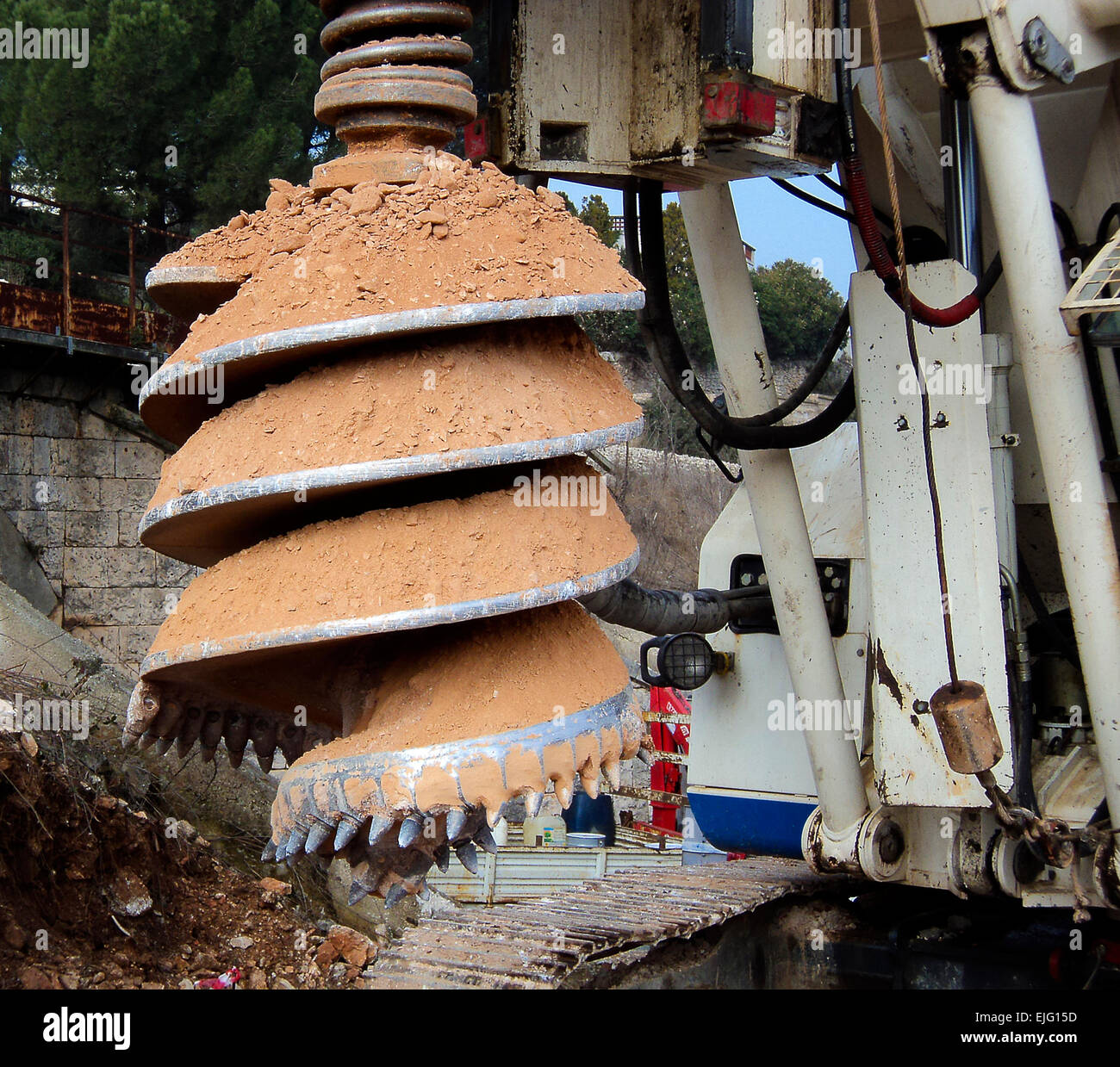 detail drilling machine boring holes in ground during construction road