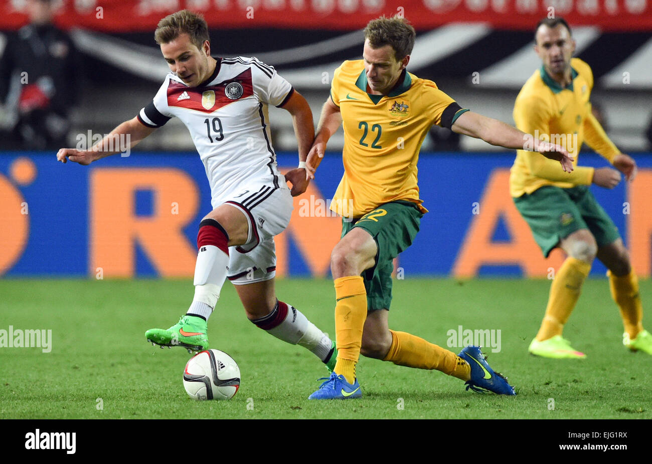 Germany's Mario Goetze (l) and Australia's Alex Wilkinson in action  during the international friendly Germany vs Australia in Kaiserslautern, Germany, 25 March 2015. Photo:  Uwe Anspach/dpa Stock Photo