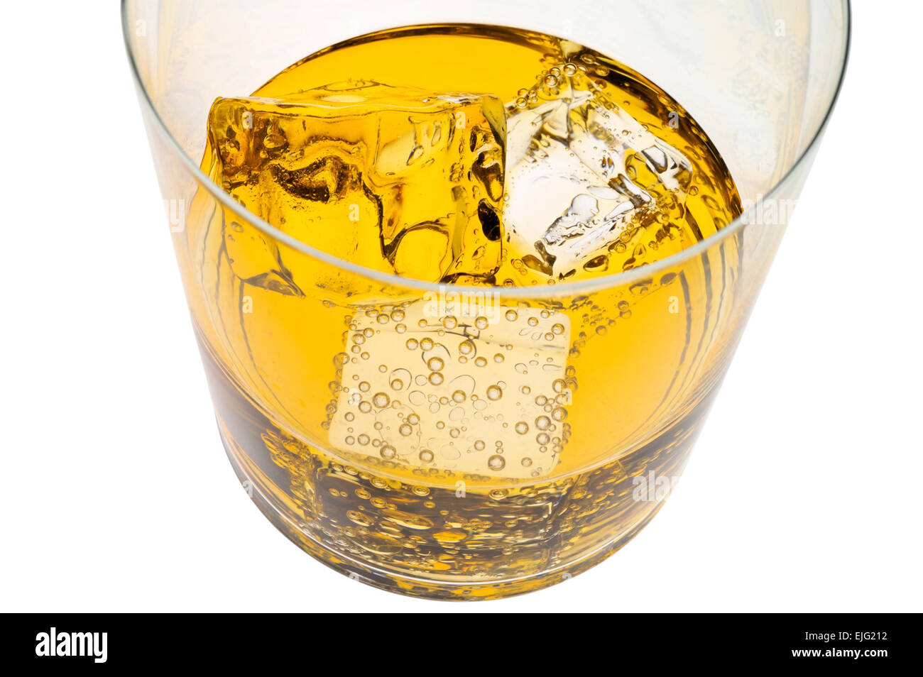 Glass of yellow drink with ice closeup with clipping path Stock Photo