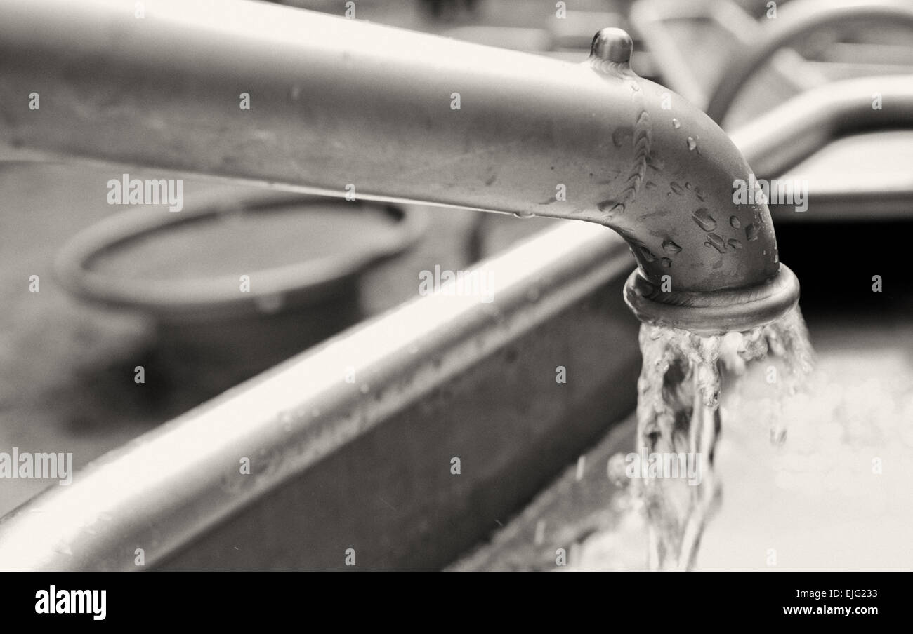 Water drops flowing from metal clean water tap Stock Photo Alamy