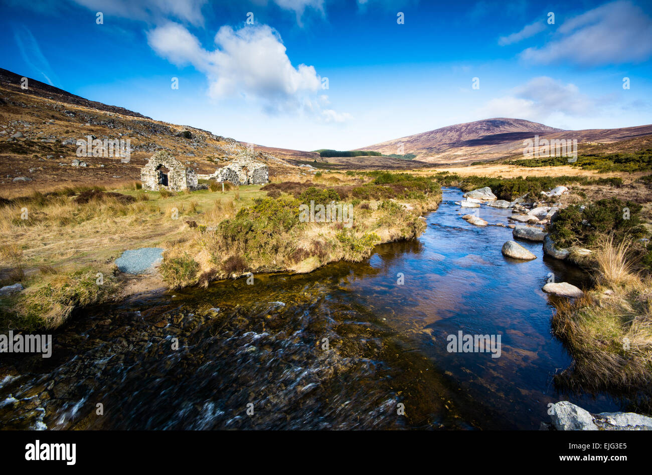 River, mountain and ruins in Wicklow Mountains National Park at Wicklow Gap Stock Photo