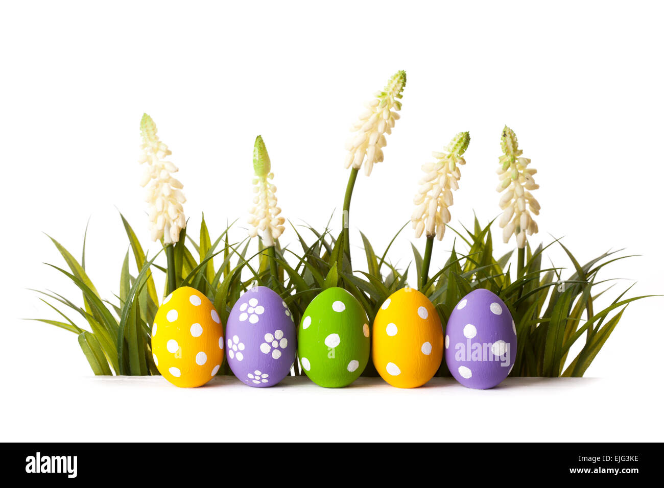 Easter Eggs with flower on Fresh Green Grass over white background Stock Photo