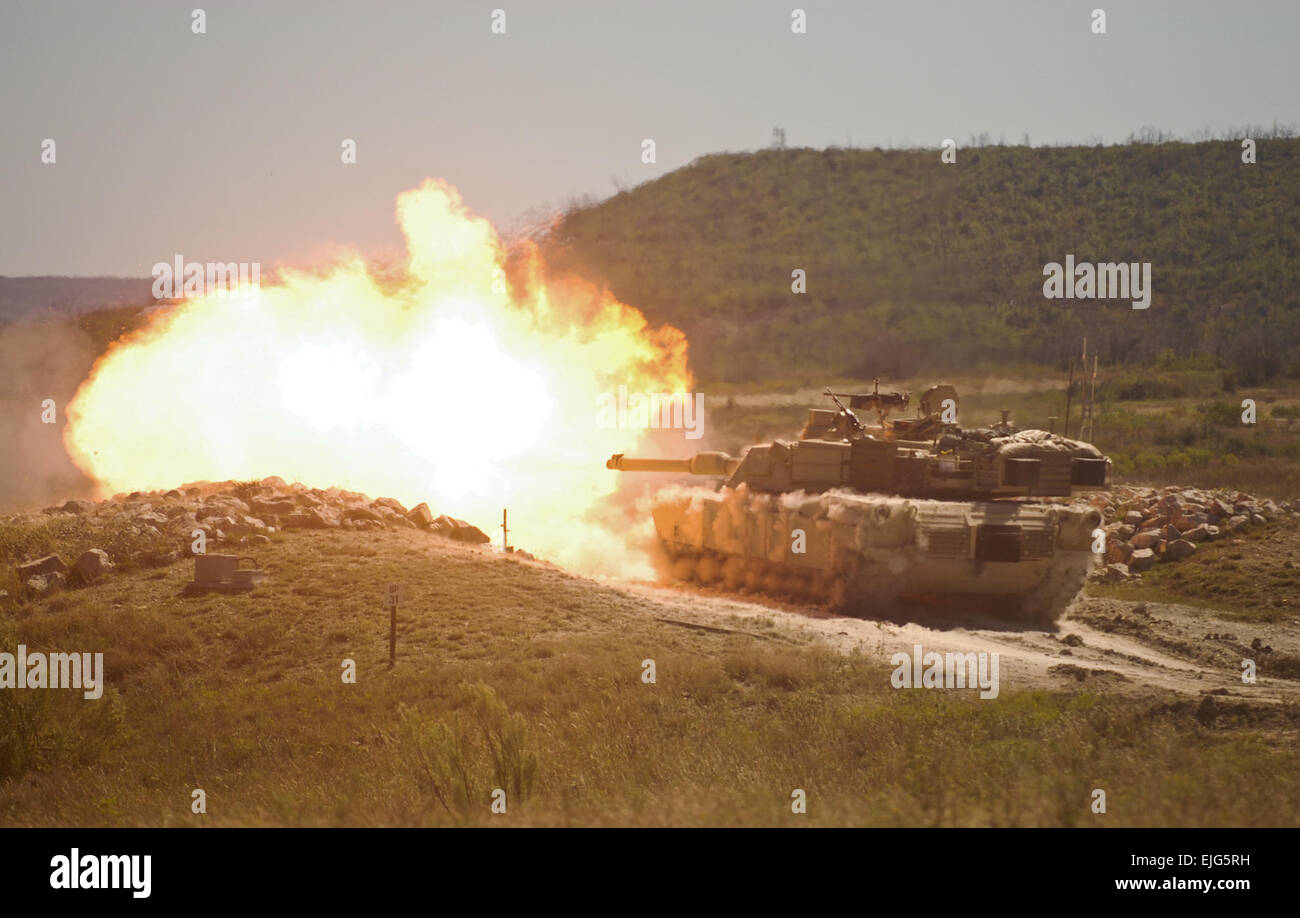A burst of fire erupts from the muzzle of a 2nd Armored Brigade Combat ...