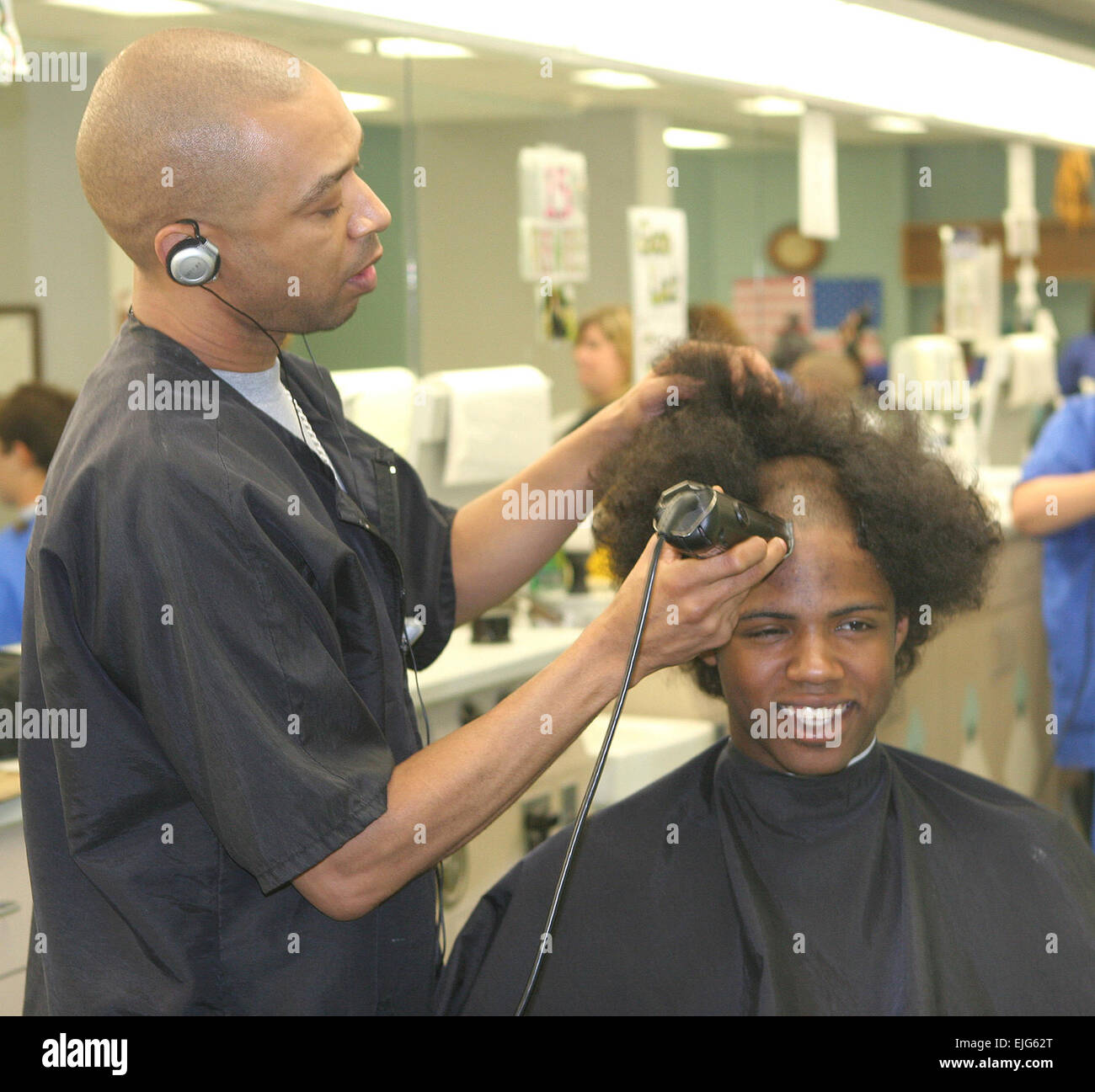 A Bushy Haired New Cadet Receives His First Haircut From