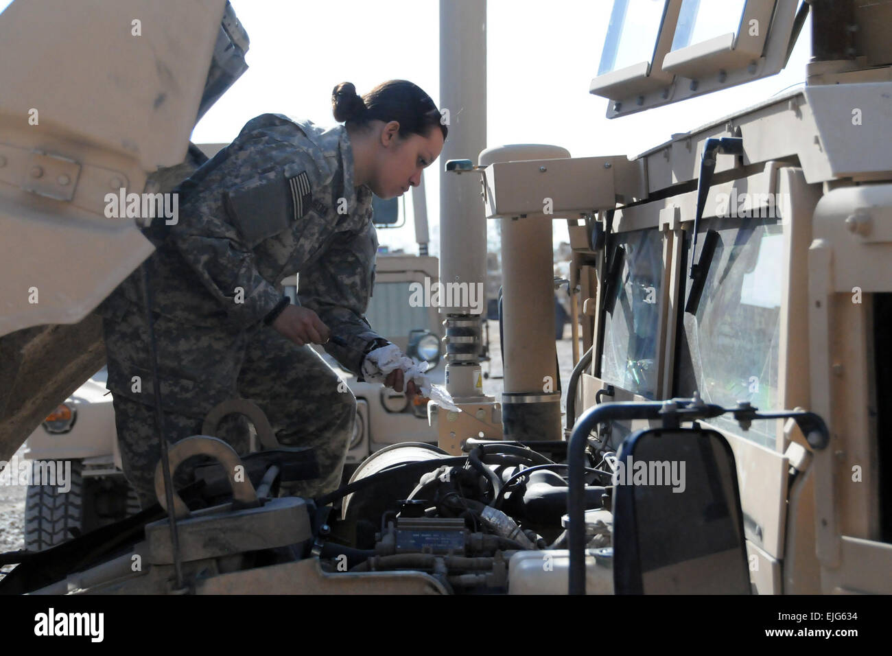 Spc. Soledad Siordia, a driver with Bravo Company, 1-185th Armor Combined Arms Battalion, 81st Brigade Combat Team, California Army National Guard, conducts maintenance on a vehicle Feb. 5, 2009 at Contingency Operating Base Speicher, Iraq.  About 900 California National Guardsmen deployed with the 81st BCT based out of Seattle in support of Operation Iraqi Freedom in August.  They are scheduled to return home this summer. Stock Photo