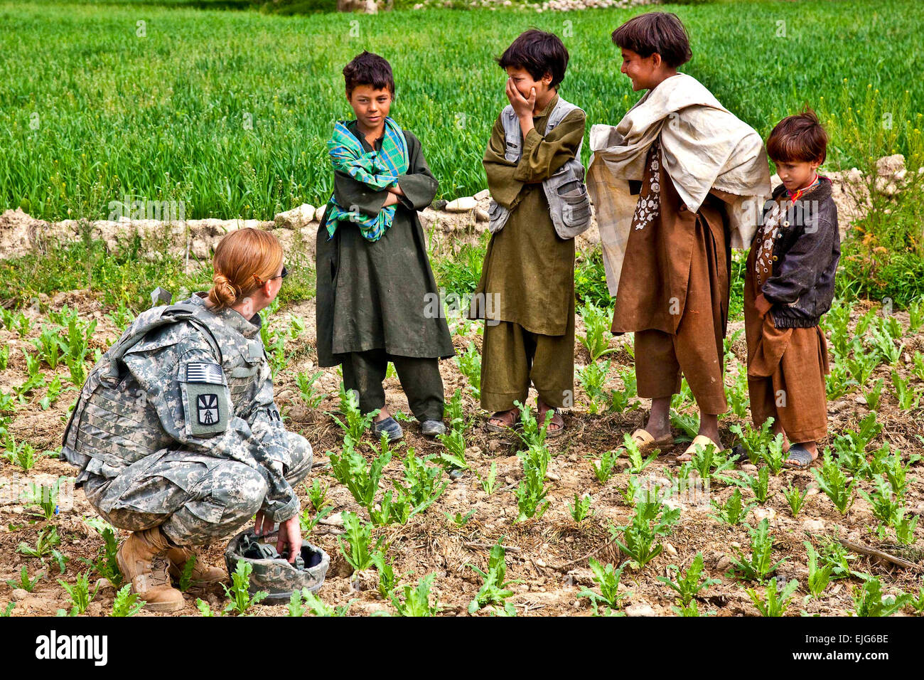 U.S. Army Capt. Rebecca Dimurco speaks with Afghan children during an operation to transport patients in Uruzgan province, Afghanistan, March 28, 2010.  Spc. Nicholas T. Loyd Stock Photo