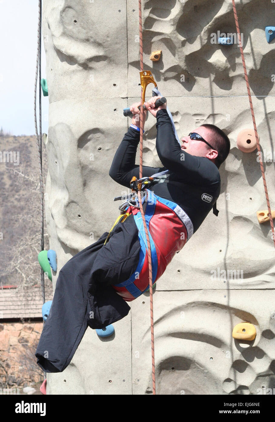 Army Cpl. Shane Parsons, a 4th Infantry Division soldier who lost both legs and suffered a traumatic brain injury in Ramadi, Iraq, shimmies up the rock-climbing wall at the National Disabled Veterans Winter Sports Clinic in Snowmass Village, Colo.  John Buehler Stock Photo