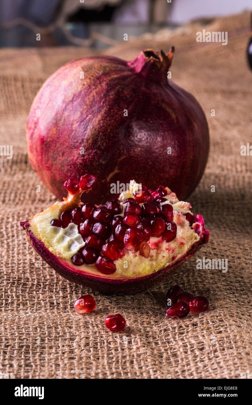 juicy ripe pomegranate on a vintage background Stock Photo