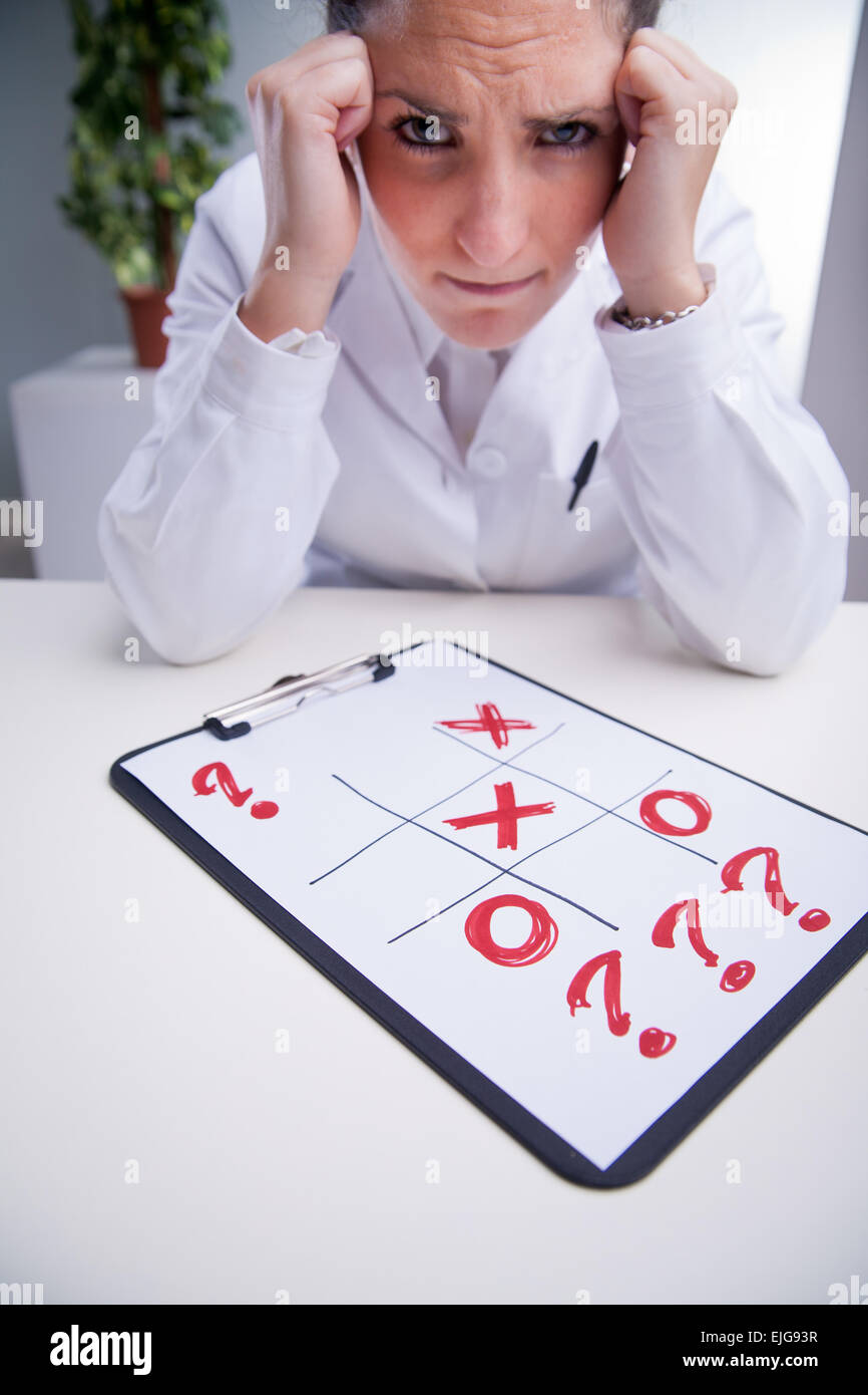 woman in a white coat looking for a solution to a very serios problem Stock Photo