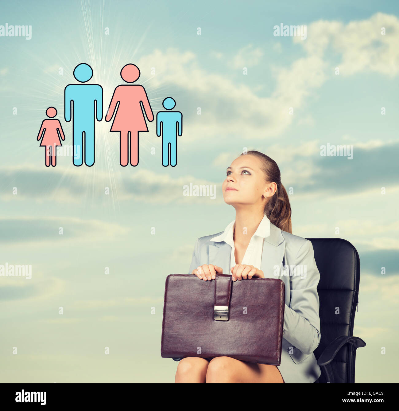 Business woman in skirt, blouse and jacket, sitting on chair imagines family. Against background of sky, clouds Stock Photo