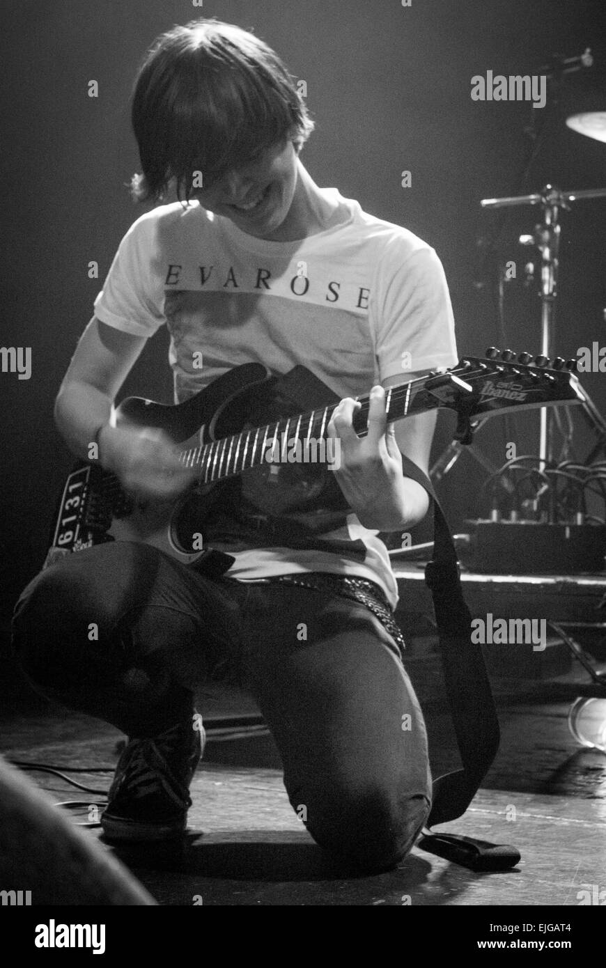 Man playing guitar on stage wearing an Eva Rose t-shirt but ...