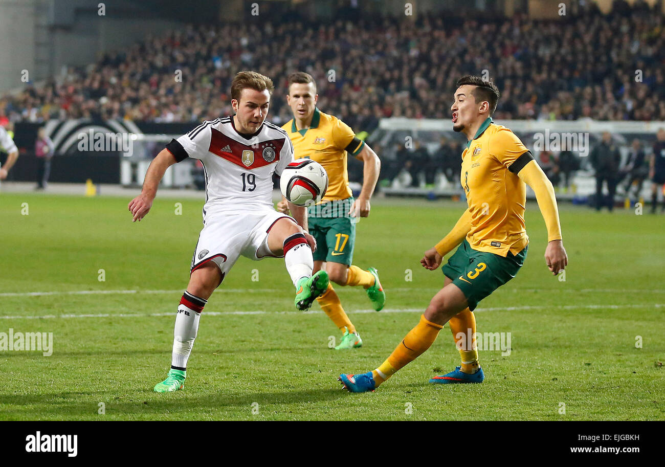 Germany's Mario Goetze (FC Bayern Muenchen) (L) against Jason Davidson (West Bromwich Albion) during the friendly match between Germany and Australia, Fritz-Walter-Stadion in Kaiserslautern on March 25., 2015. Stock Photo