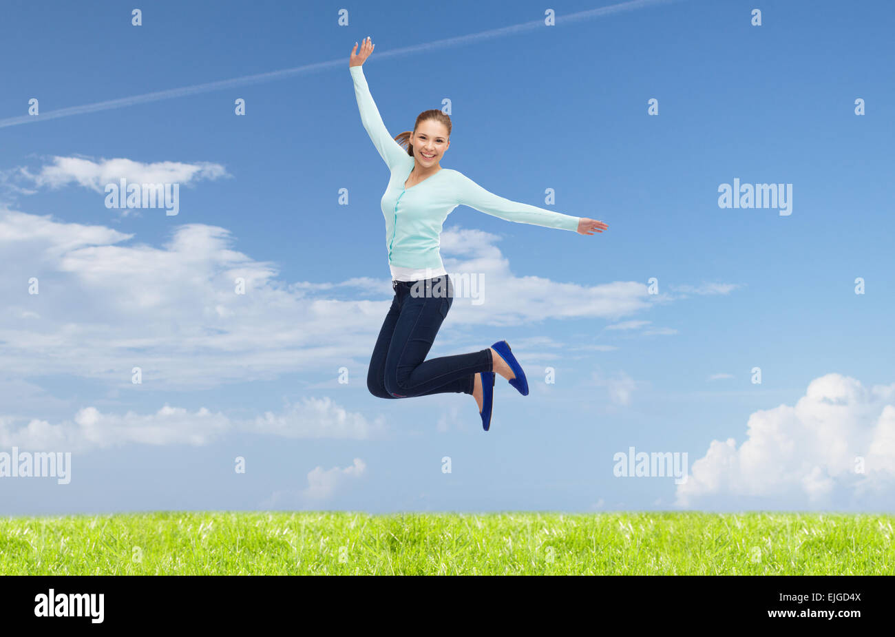 smiling young woman jumping in air Stock Photo - Alamy