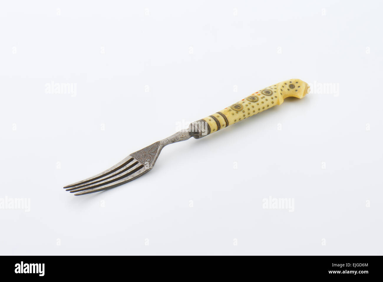 Vintage dinner fork with engraving on the face and ornate handle Stock