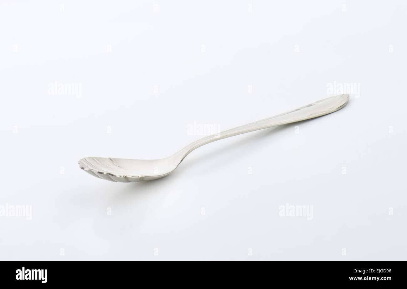 Cheese spoon with finely decorated cup and handle Stock Photo