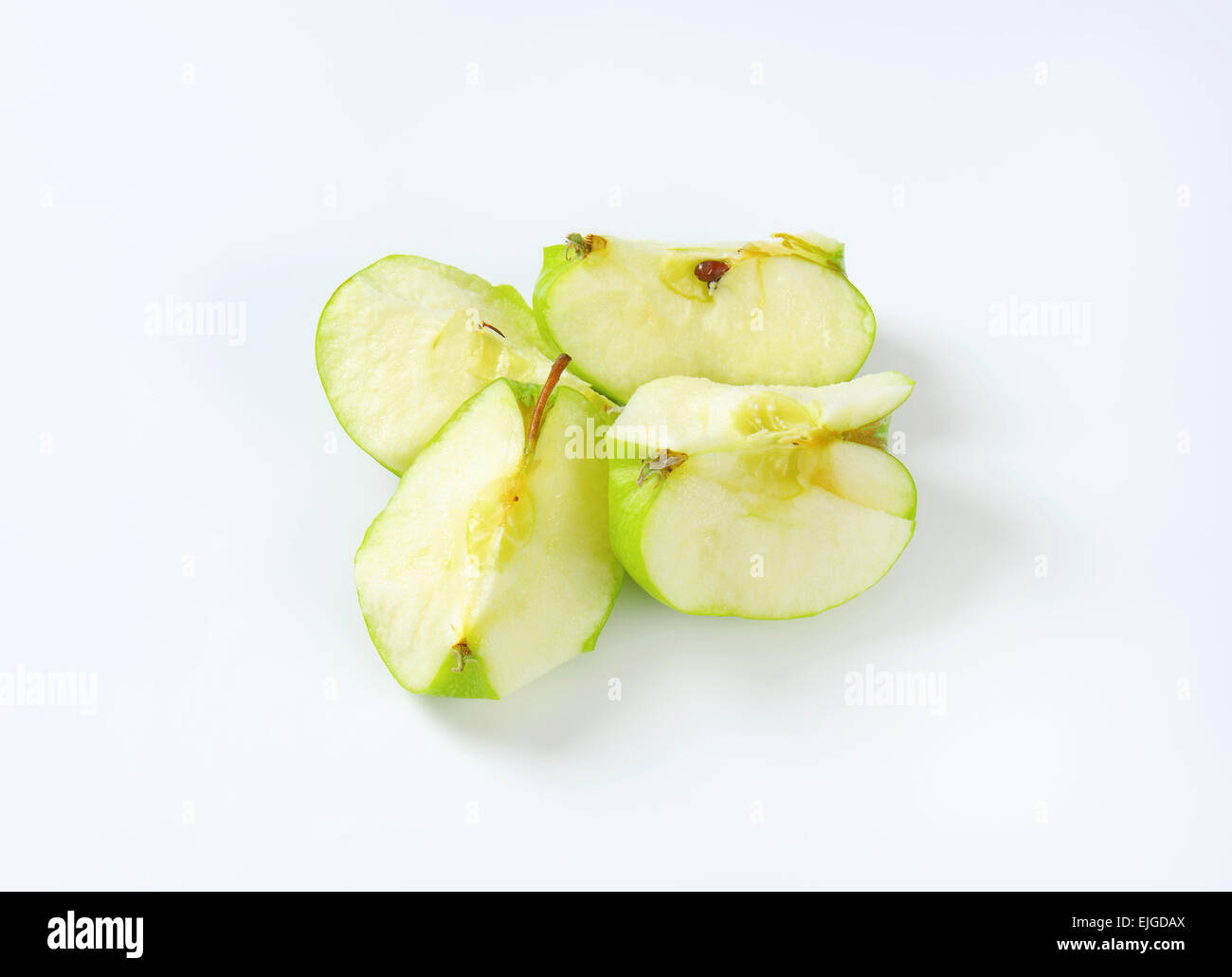 Green apple cut into quarters Stock Photo Alamy