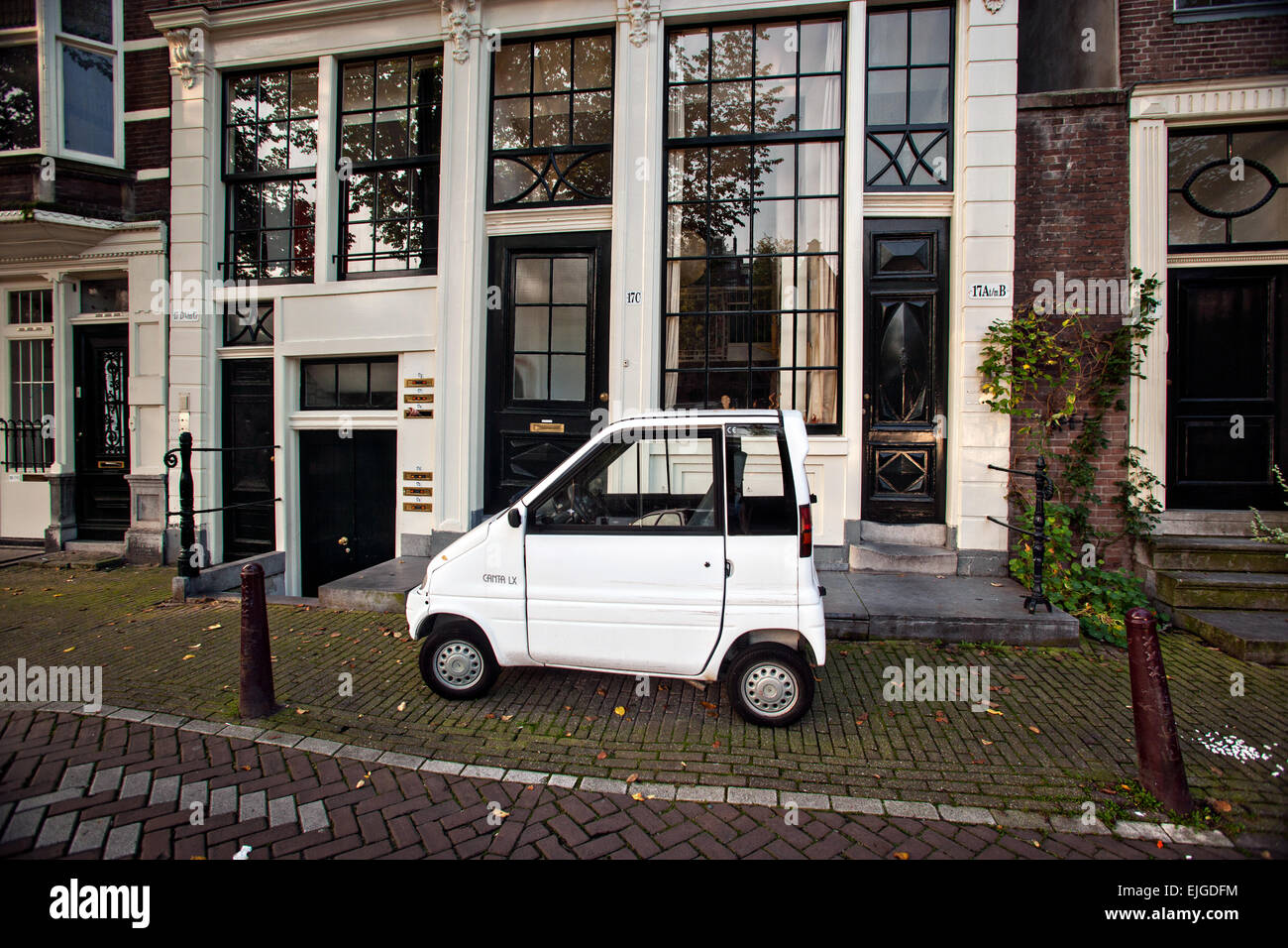 A Canta LX two-seat microcar created for disabled drivers parked along a street in Amsterdam. Stock Photo